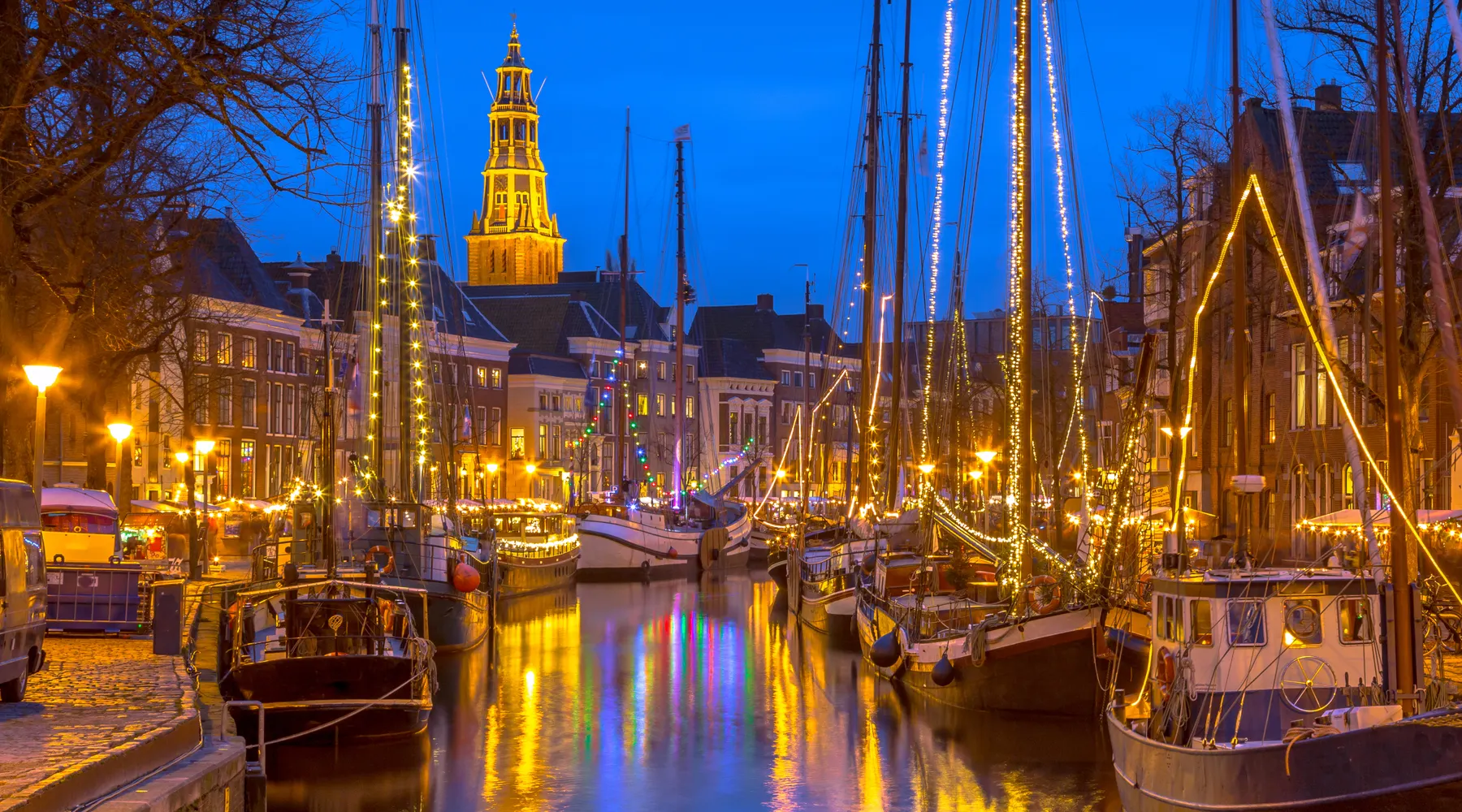 Lighted boats in winter in Groningen