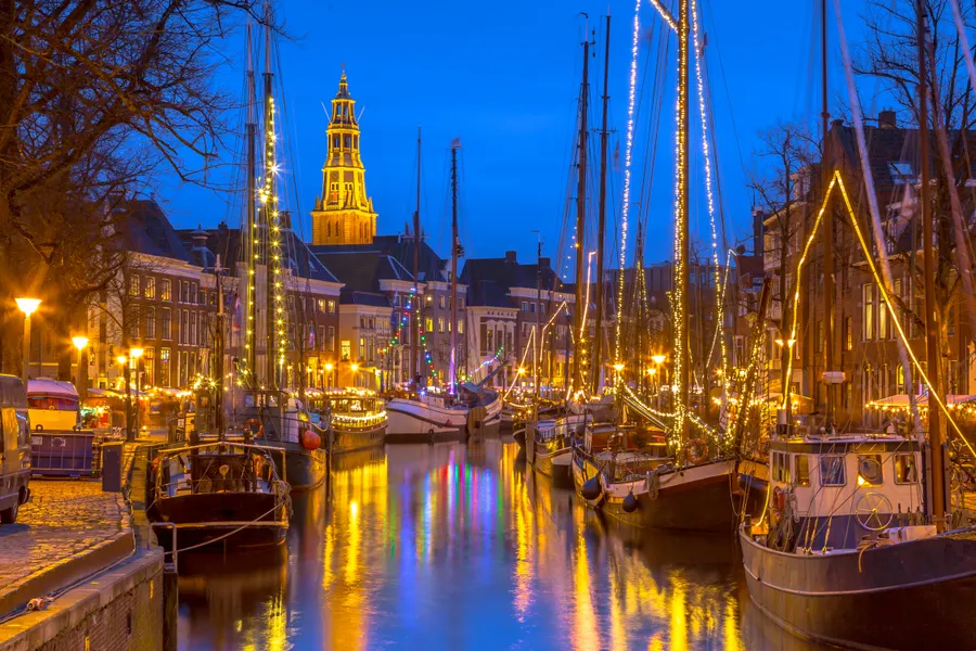 Lighted boats in winter in Groningen