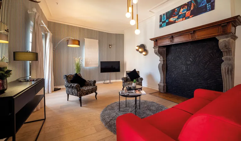 Salon avec canapé de la Suite Sélys à l’Hôtel Sélys Liège