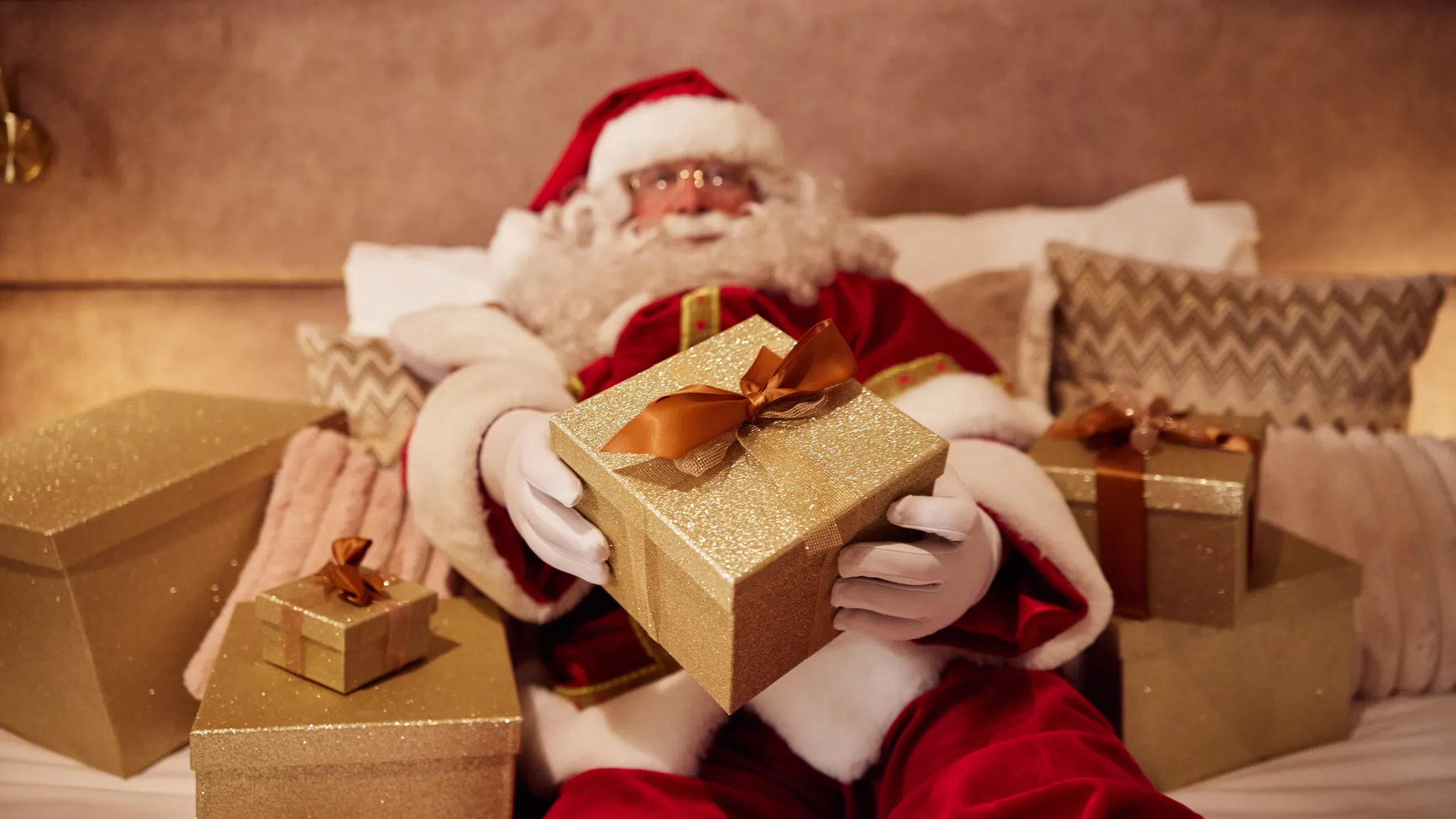 Santa Claus in bed at Van der Valk Hotel Gorinchem-A15 with lots of packages