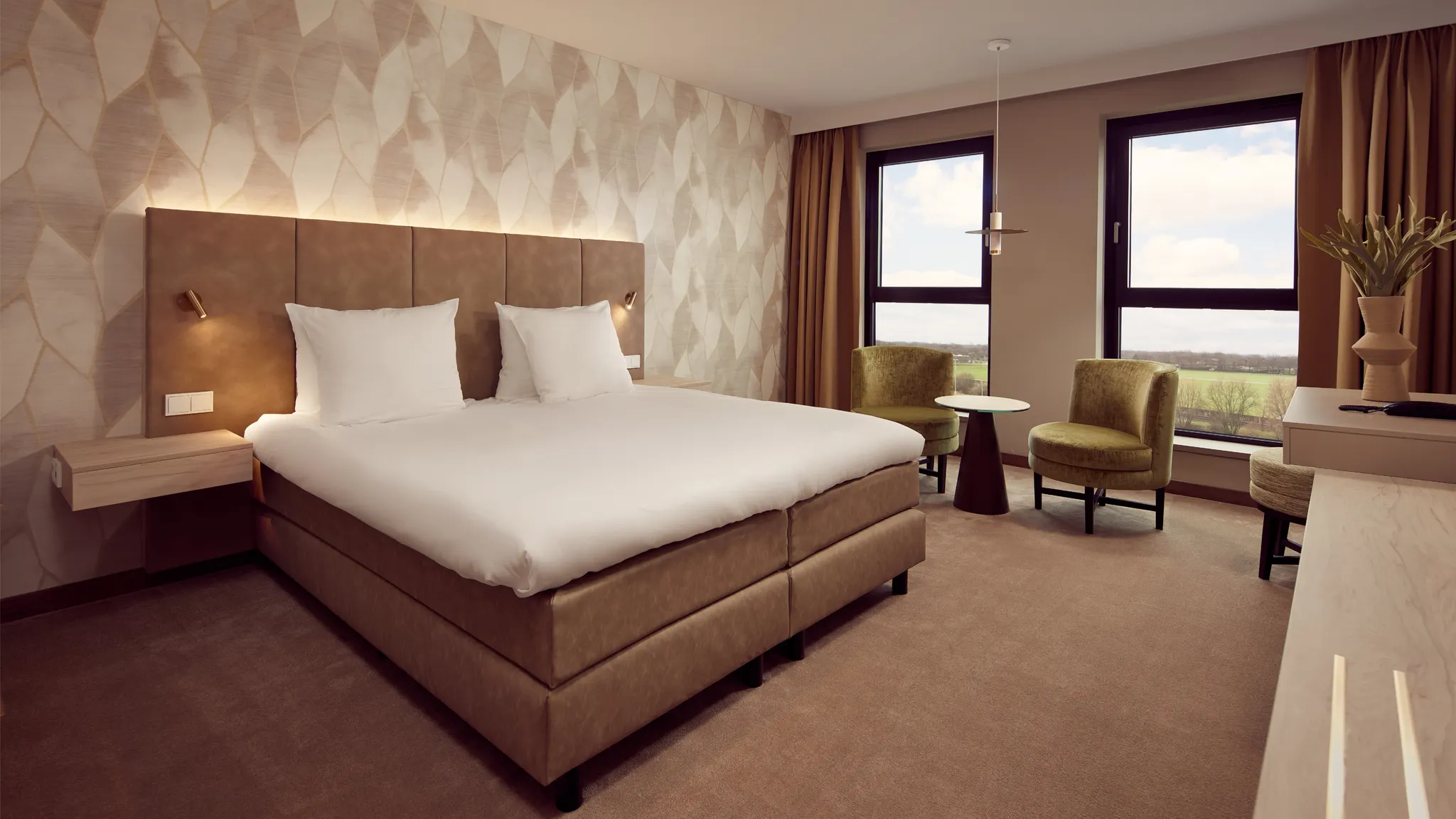 Chambre d'hôtel moderne et confortable avec lit double et coin salon à l'hôtel Van der Valk Gorinchem-A15