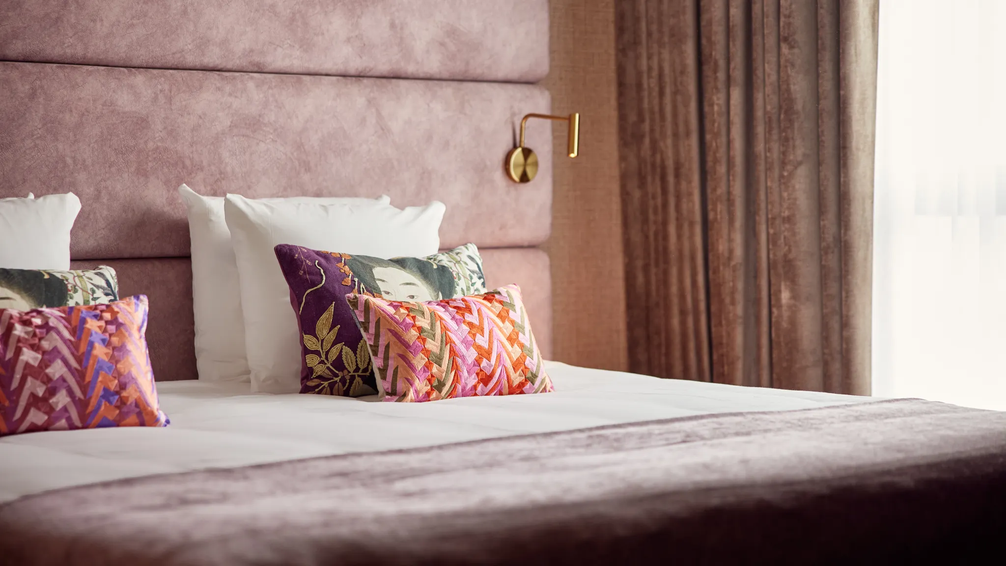 Kleurrijke kussens op een comfortabel tweepersoonsbed in de Family Suite van Van der Valk Hotel Gorinchem-A15