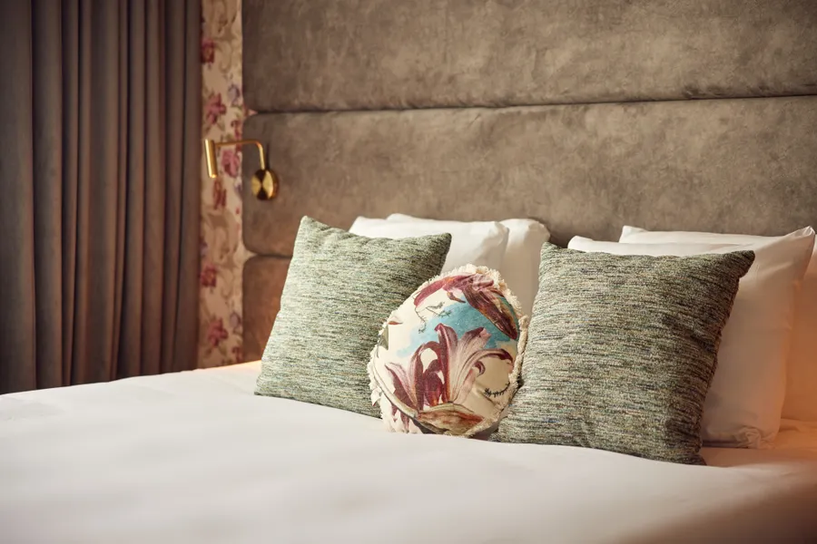 Sfeervol opgemaakt bed met sierkussens in de Spa Suite van Van der Valk Hotel Gorinchem-A15