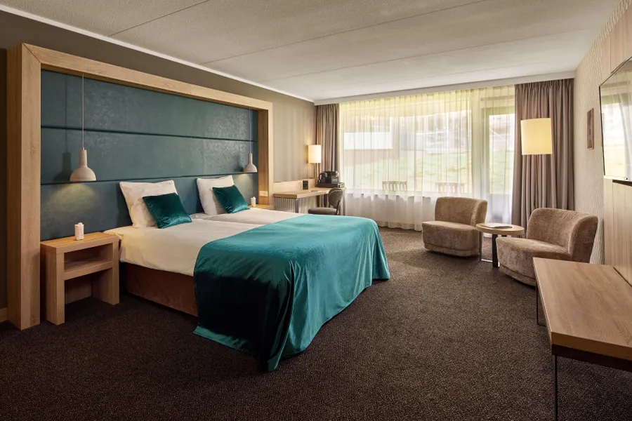 Ruime comfort hotelkamer met tweepersoonsbed en zithoek in Van der Valk Hotel Leusden-Amersfoort