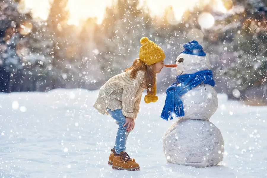 meisje-speelt-sneeuwpop